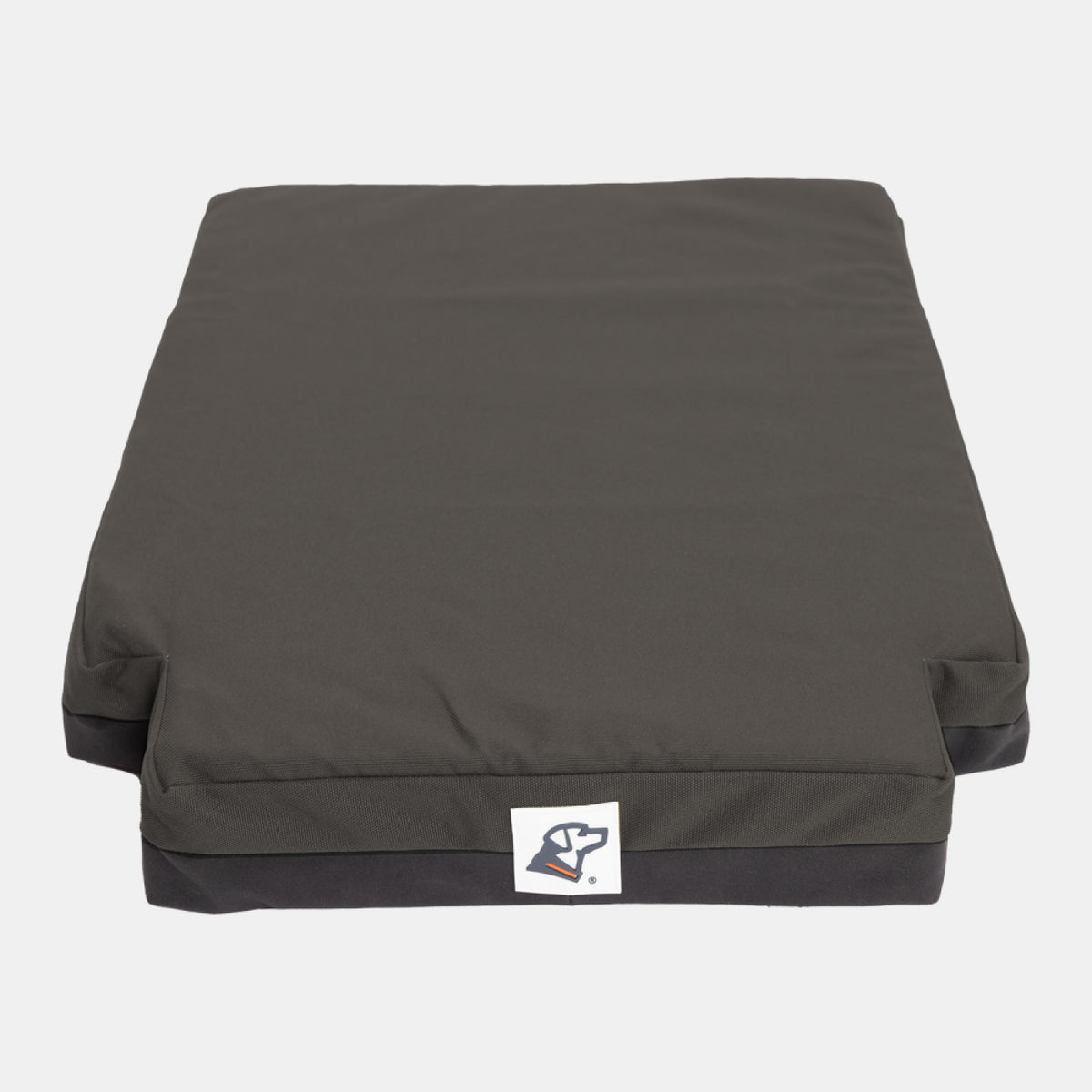 A rectangular, dark gray dog bed with a removable cover and a white tag featuring a simple dog logo on the front. The bed is thick and cushiony, making it perfect for use in a dog kennel or dog crate, shown against a plain white background.