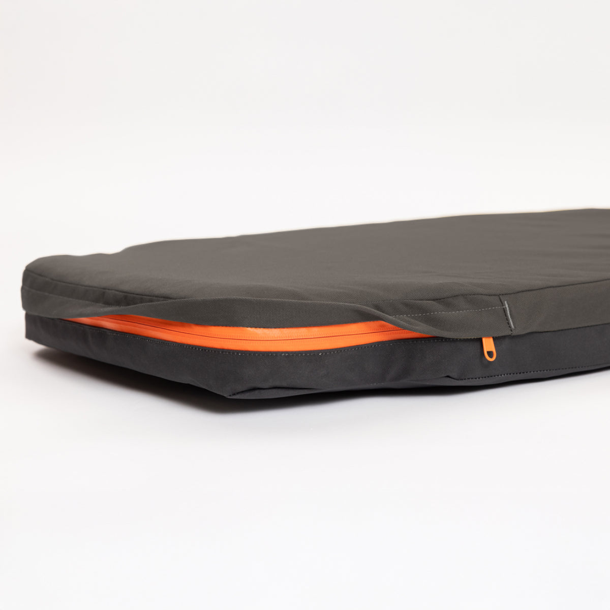 A black fabric case with an orange zipper, partially unzipped, lies flat on a white surface—an essential accessory for organizing your outdoor gear.
