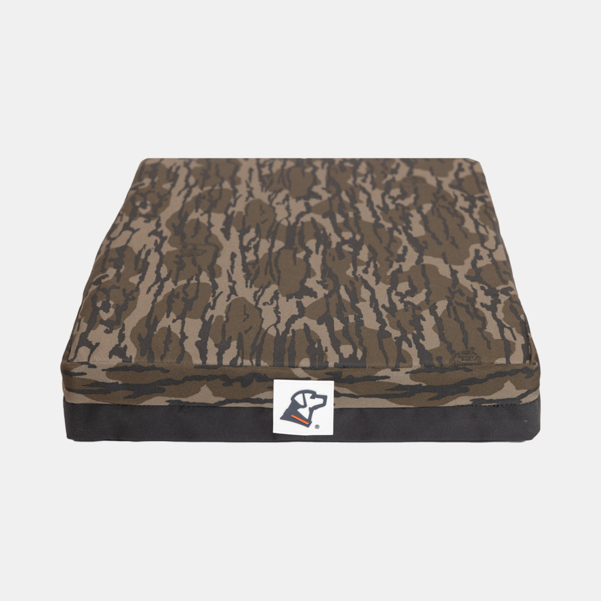 A rectangular cushion with a brown and black camouflage pattern and a small logo patch on the front, set against a white background—perfect for outdoor gear enthusiasts or as a comfortable rest spot for your hardworking hunting dog.