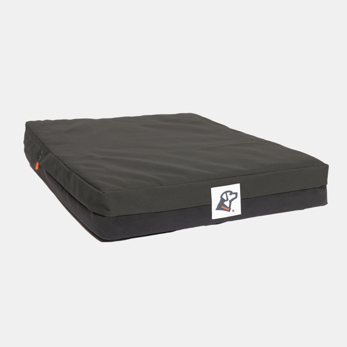 Rectangular black pet bed with a small white logo tag on the front edge, ideal for providing comfort to your working dog in the kennel, placed on a plain white background.
