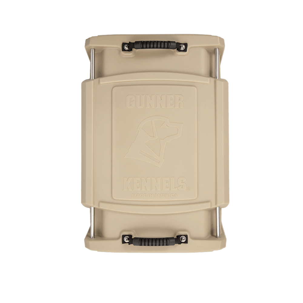 Top view of the GUNNER G1™ KENNEL - MOSSY OAK BOTTOMLAND TAN, featuring two black handles on each end and an embossed dog head outline on the lid.