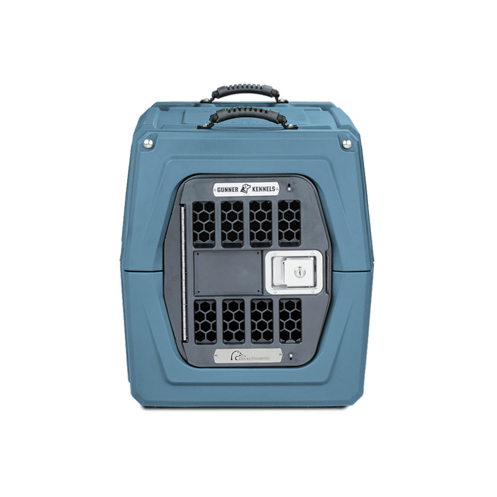 The GUNNER G1™ KENNEL - Ducks Unlimited Blue is a hard-sided pet carrier with black ventilation grid, white front latch, and sturdy top handles, inspired by Ducks Unlimiteds dedication to waterfowl habitats for secure transport.