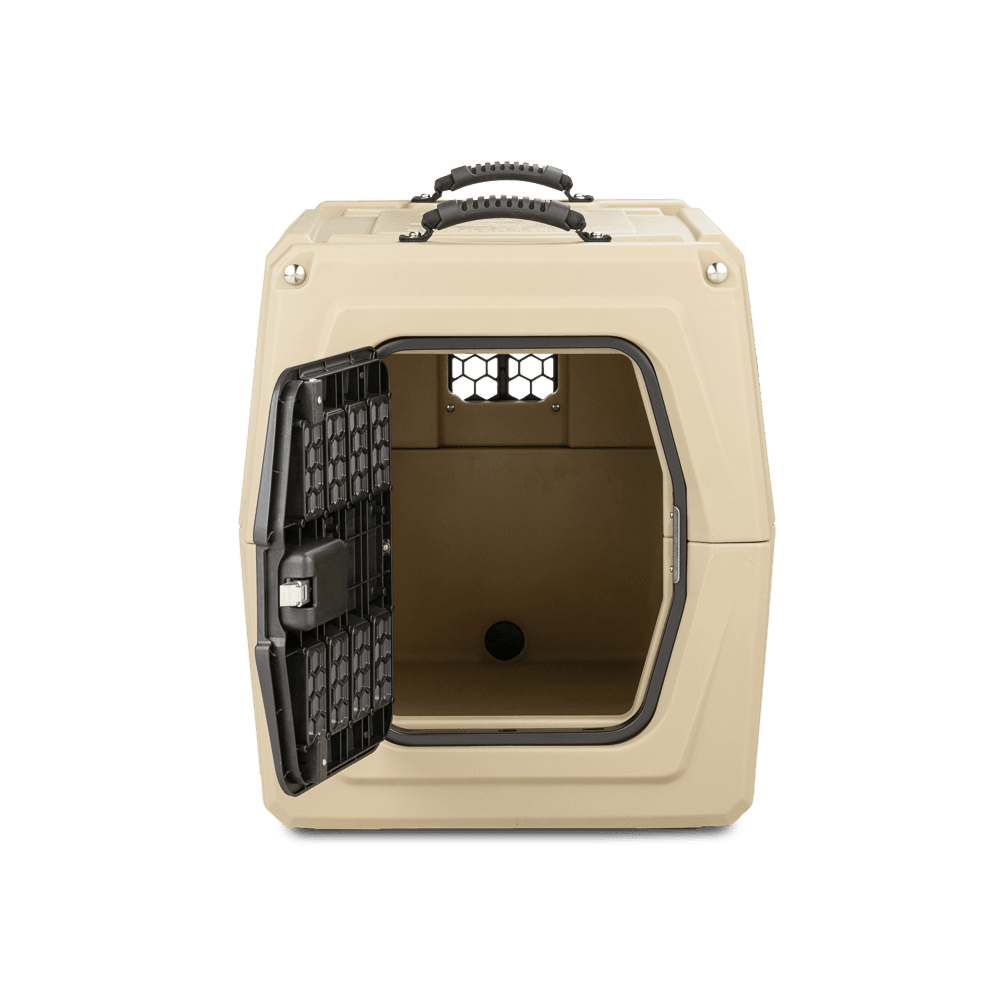 The GUNNER G1™ KENNEL - MOSSY OAK BOTTOMLAND TAN is a durable beige plastic dog crate featuring a black metal door open to reveal the empty interior, with a small rear ventilation window and two top carrying handles.