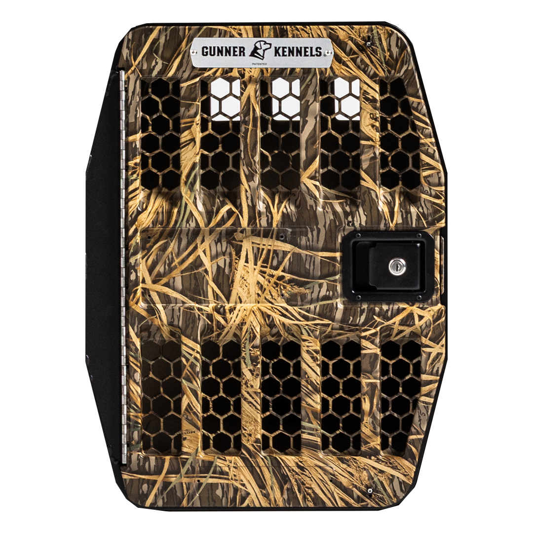 The GUNNER G1™ KENNEL DOOR features a camouflage pattern, black honeycomb-shaped ventilation holes, a right-side lockable handle, durable aluminum frame, and the GUNNER logo at the top.