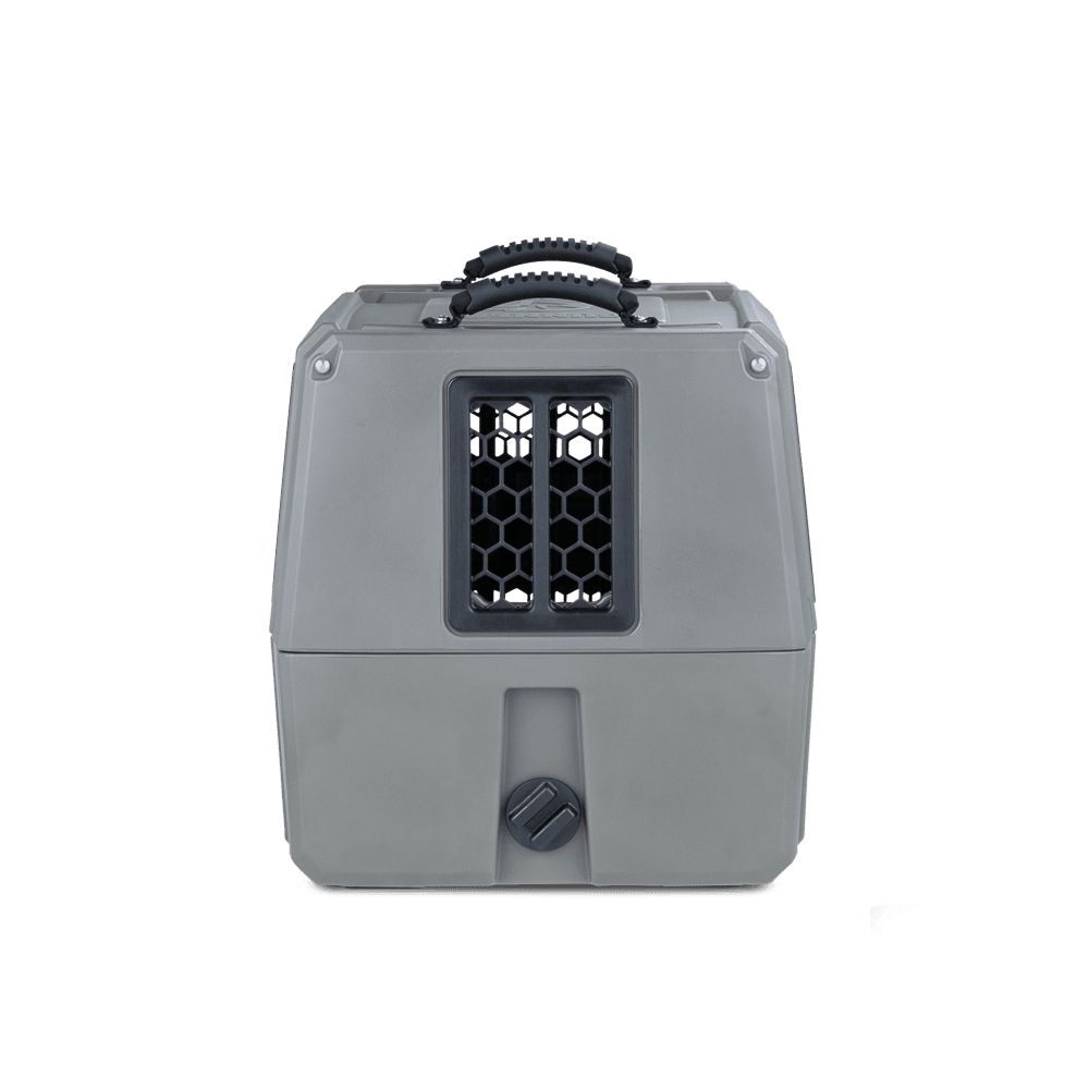 The GUNNER G1™ KENNEL in gunmetal is a gray, hard-sided, durable dog crate with a black top handle and a front ventilated honeycomb-patterned window, shown against a white background.