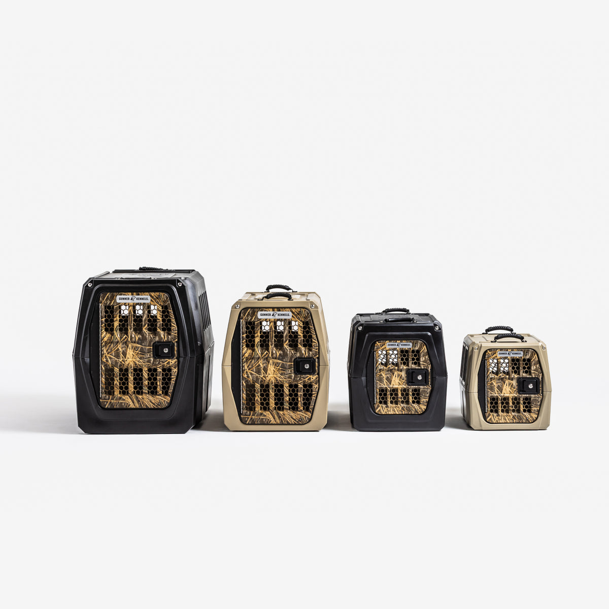 Four GUNNER G1™ KENNEL - BLACK/SHADOW GRASS models in different sizes are lined up on a white background, with black trim, clear gold-accented fronts, top handles, and ventilation holes for safe and stylish pet travel.