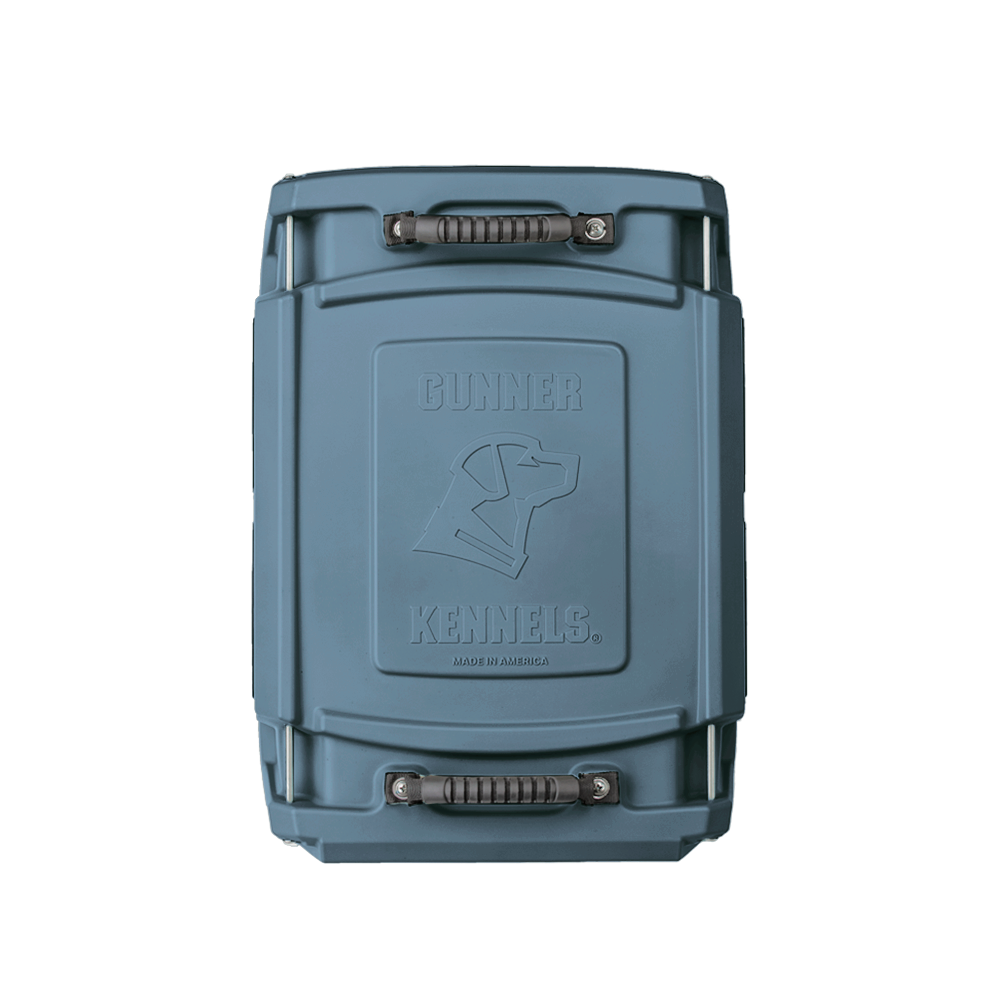 The GUNNER G1™ KENNEL - Ducks Unlimited Blue is a rugged, hard-sided kennel with secure handles and embossed branding, viewed from above on a white background—ideal for waterfowl habitat adventures.