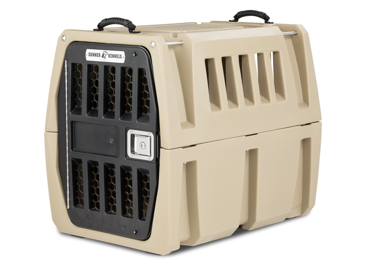The GUNNER G1™ Kennel - GUNNER YARD is a beige, heavy-duty double-walled crate with a black metal front door, side ventilation slots, and top handles. Designed for pet transport, it offers a sturdy and secure look.