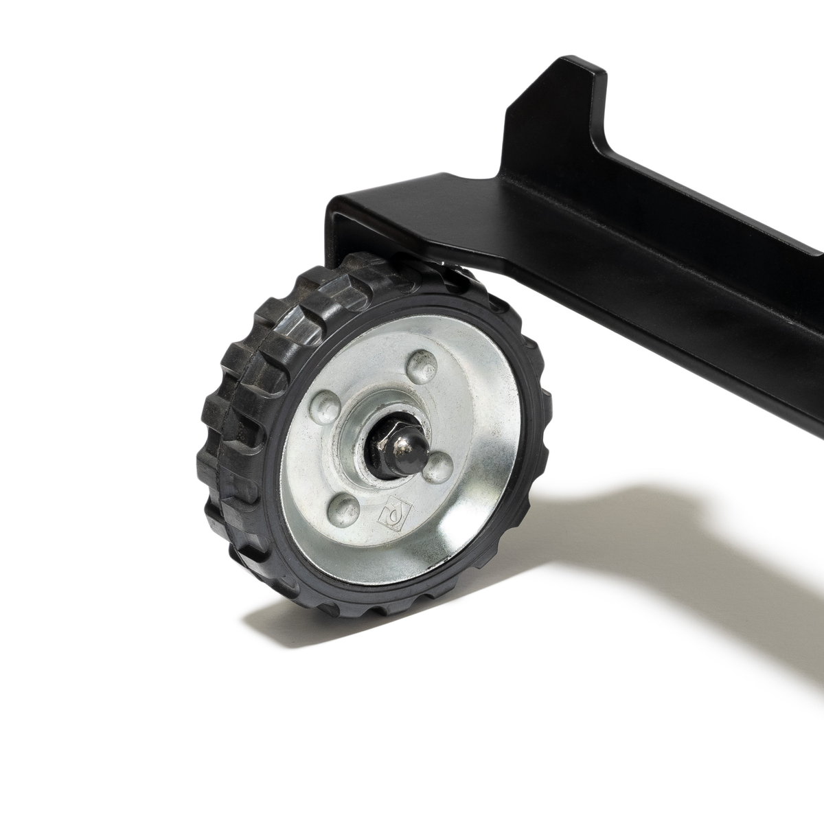 Close-up of the GUNNER KENNEL WHEEL KIT in black and silver, attached to an Intermediate kennel’s metal frame and casting a shadow on a white background.