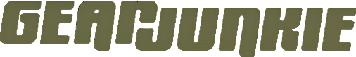 The word GearJunkie is written in bold, olive green, all-caps, block-style letters against a light gray background—perfect for fans of outdoor gear or anyone searching for the best kennel or dog crate reviews.