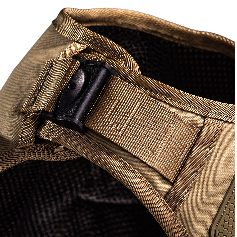 Close-up of a tan fabric strap with a black plastic buckle attached to dark mesh material, part of the GUNNER Waterfowl Dog Vest Marsh.