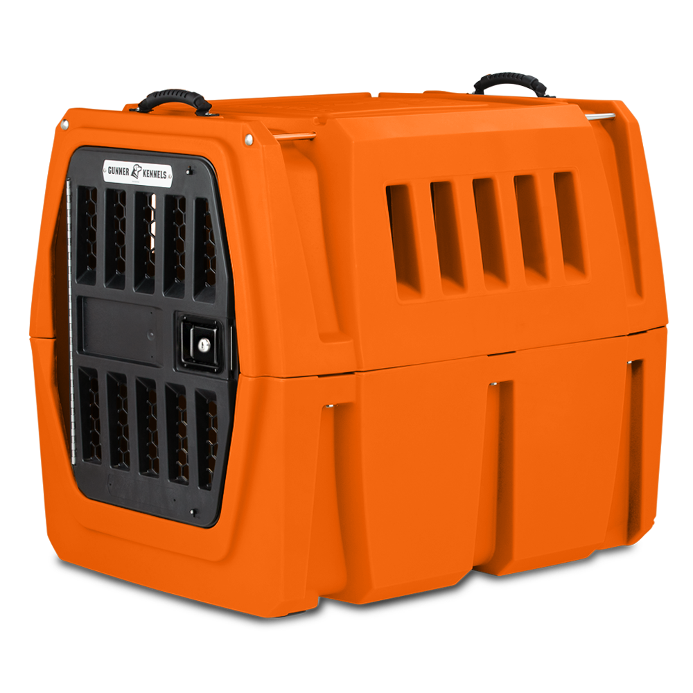 The GUNNER G1™ Kennel - GUNNER YARD is an orange, double-walled dog crate with ventilation slats, a black metal door, top handles for easy carrying, and shock protection—engineered by GUNNER for safe and secure animal transport.