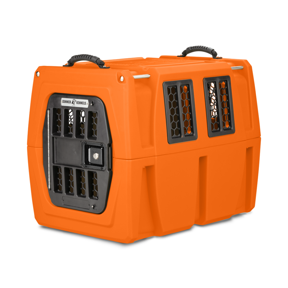 The GUNNER G1™ KENNEL - BLAZE ORANGE features black grated windows and door, sturdy top handles, and side ventilation openings to ensure safe animal transport.