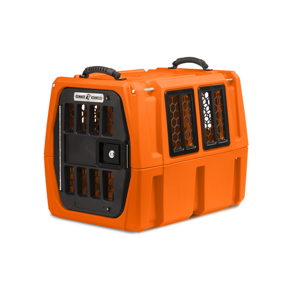 The GUNNER G1™ Kennel - GUNNER YARD is a durable, bright orange double-walled dog crate with black handles and side/front ventilation grilles, offering shock protection for secure animal transport.