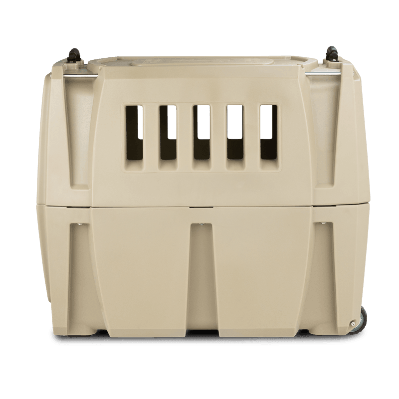 The GUNNER G1™ KENNEL - TAN is a beige, double-walled plastic pet carrier with ventilation slots and small wheels—engineered for shock protection, making it one of the safest dog crates for animal transport.