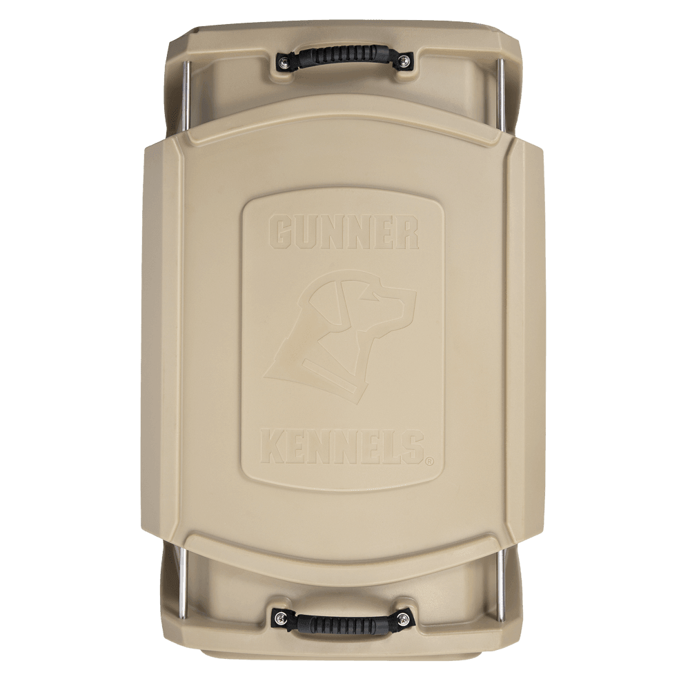 Top-down view of the GUNNER G1™ KENNEL - TAN, a double-walled crate with black handles and an embossed dog head logo on the lid, engineered for maximum safety and enhanced shock protection.
