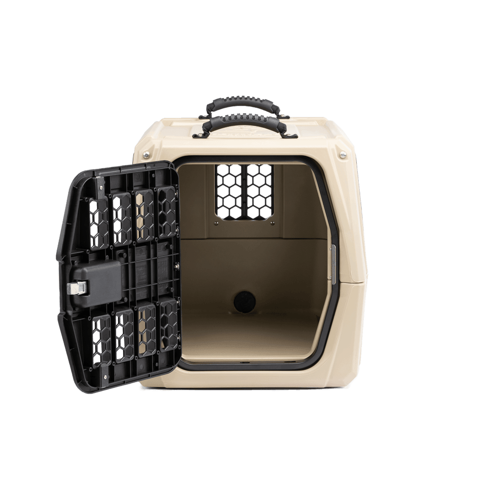 The GUNNER G1™ KENNEL - TAN features a sturdy handle, black metal door opening left, spacious double-walled interior for shock protection, and ventilation holes in a simple, functional design.