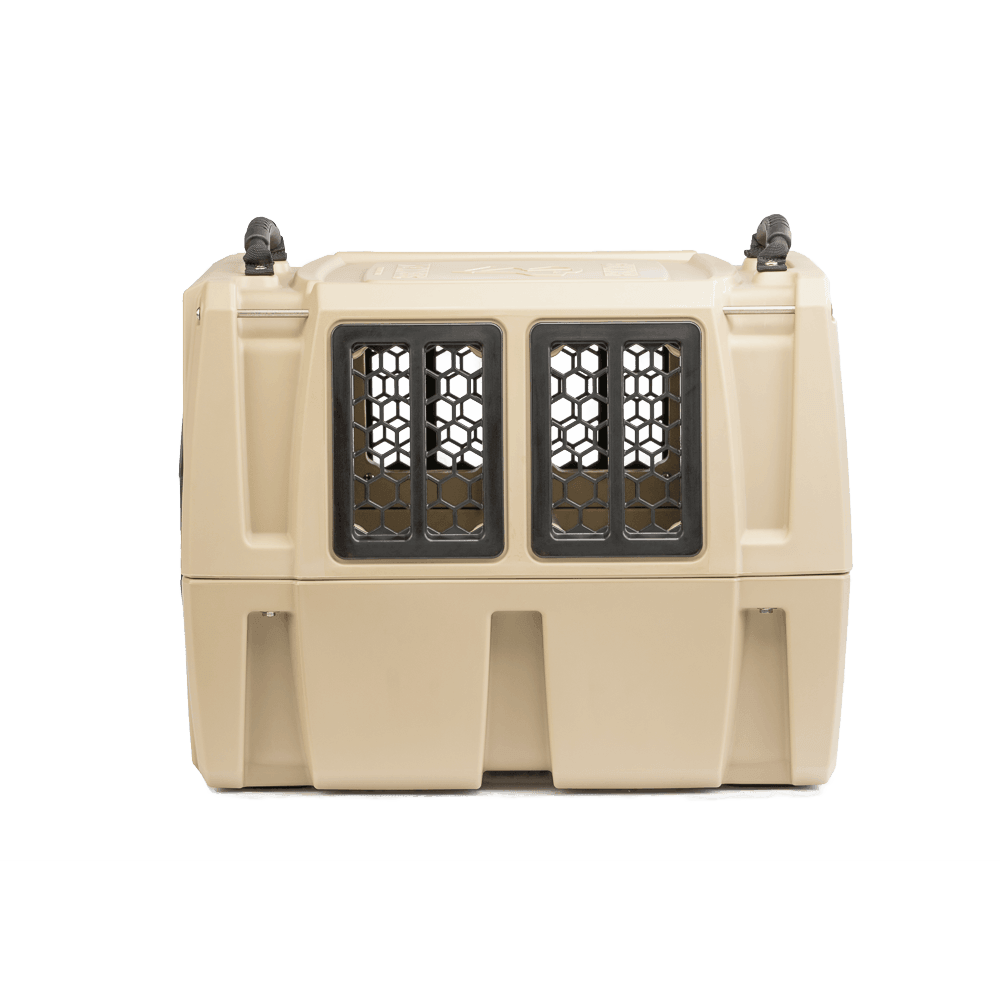 The GUNNER G1™ KENNEL - TAN is a double-walled pet carrier with black, vented windows on the front and sides for safe animal transport, offering added shock protection. Its shown against a white background.