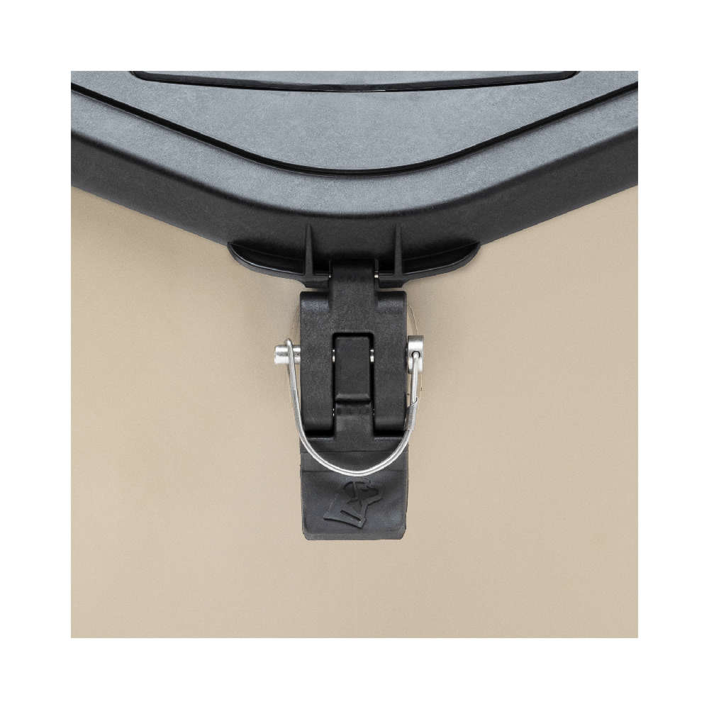Close-up of a black latch with metal pin securing the lid of the GUNNER FOOD CRATE - TAN, a waterproof dog food container by GUNNER. A cup symbol is embossed on the rubber tab at the bottom of the latch for added style and function.