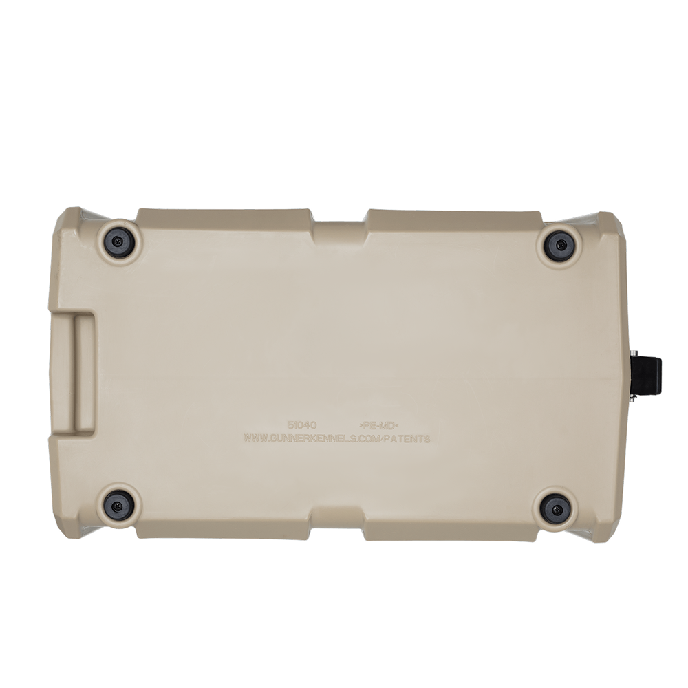 The GUNNER FOOD CRATE - TAN by GUNNER is a beige hard plastic pest-proof container, shown from the bottom with four black rubber feet at the corners, a handle on one side, and centered text plus a website on the flat surface.