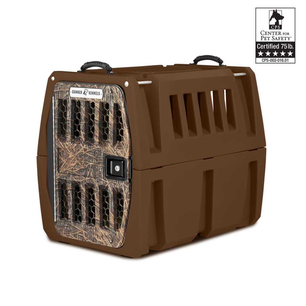 A sturdy brown dog kennel with a camo-patterned front, black handles on top, and multiple ventilation slots—ideal for any working dog. A Center for Pet Safety Certified 75 lb. badge is shown in the top right corner.