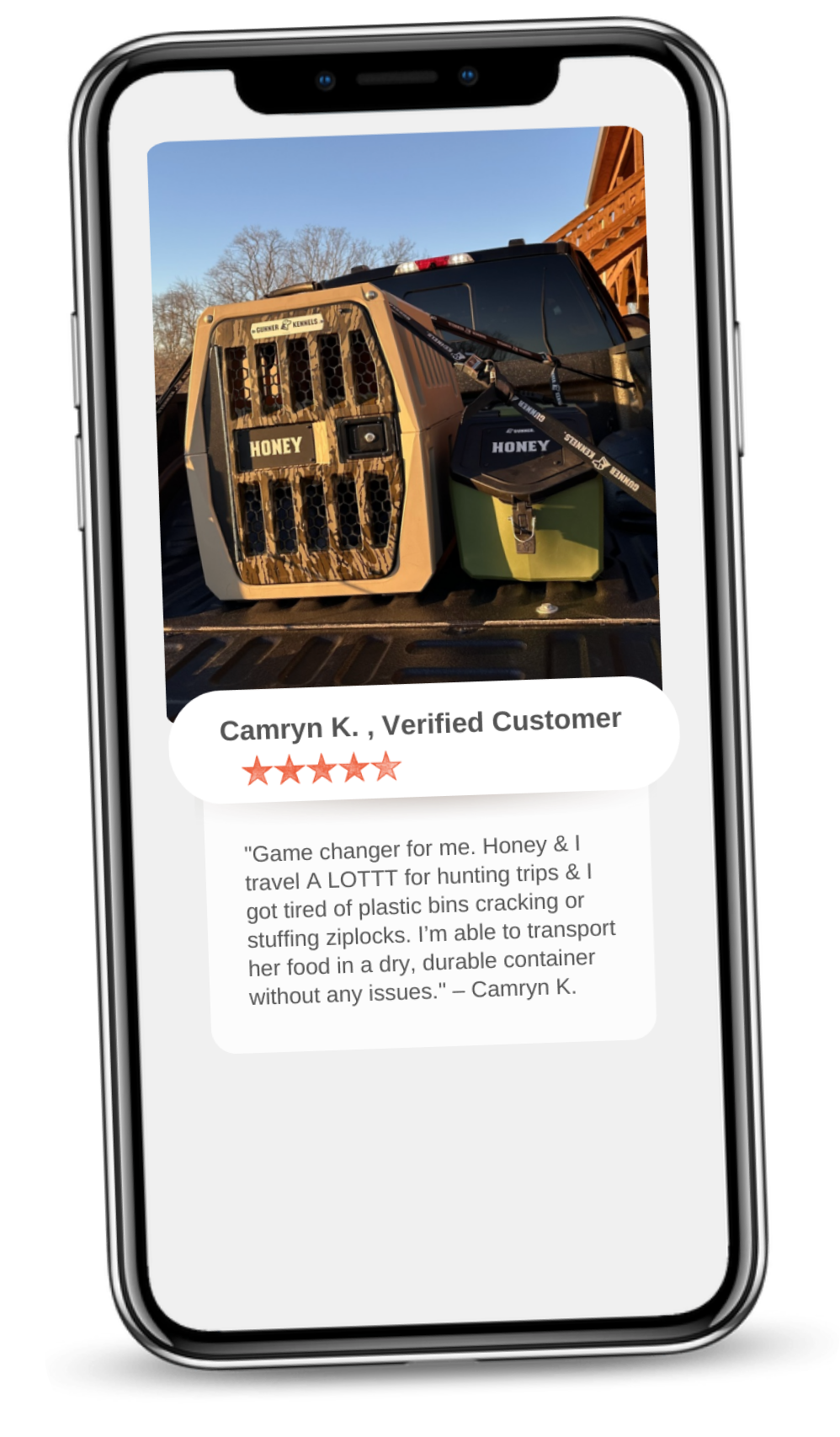 A smartphone screen displays a photo of a dog kennel labeled Honey outside with a matching container. Below, a 5-star review from Camryn K. praises the sturdy food container as essential outdoor gear for easy travel with her dog.