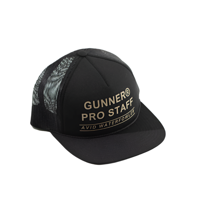 The GUNNER PRO STAFF TRUCKER is a black mesh camo hat with PRO STAFF AVID WATERFOWLER in gold on the front. Features an adjustable snapback for a perfect fit. Shown against a plain white background.
