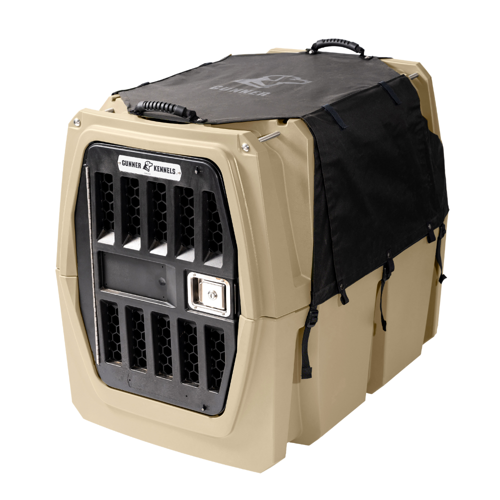 The GUNNER ALL-WEATHER KIT 2.0 is a beige and black hard-sided pet kennel with sturdy top and side handles, a metal door, ventilation holes, and a wind-resistant waterproof dog kennel cover for easy carrying.