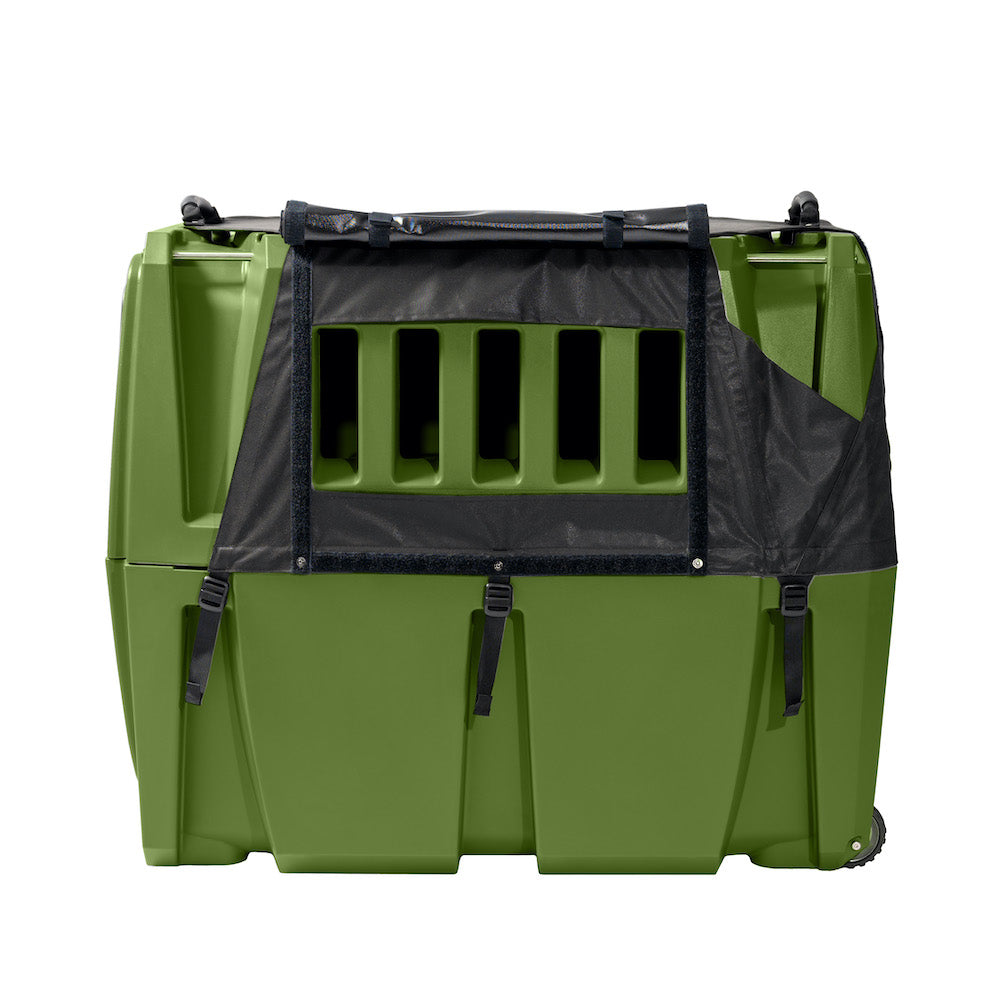 The GUNNER ALL-WEATHER KIT 2.0 includes a green plastic pet crate with top handles, ventilation slats, a partially attached black mesh cover, and a waterproof kennel cover for added protection.