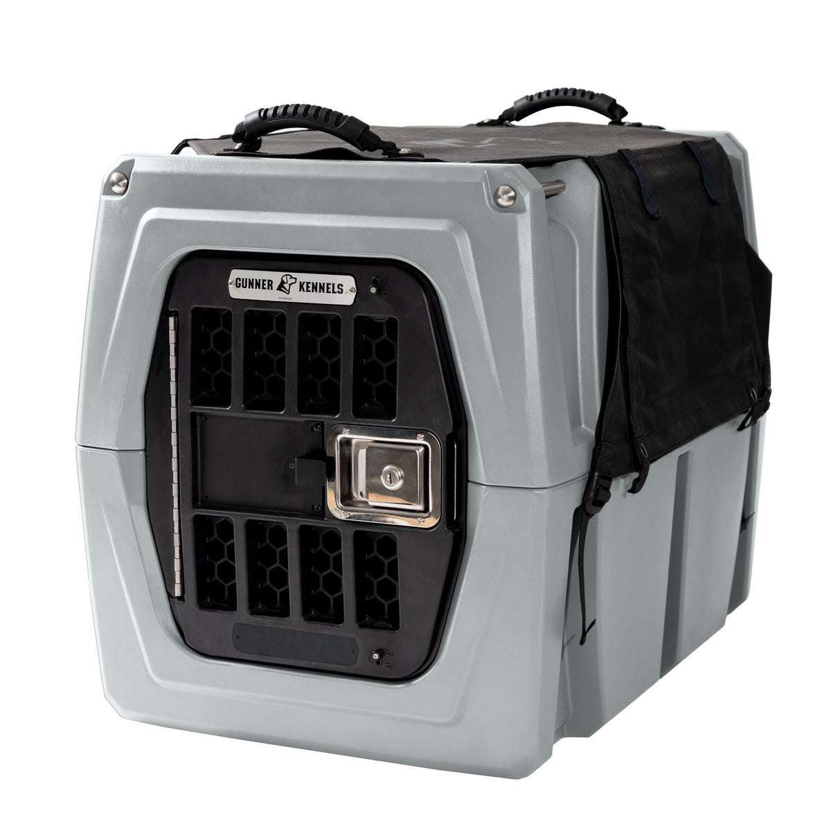 A sturdy, light gray GUNNER pet crate with a black metal door, ventilation holes, top carrying handles, and an ALL-WEATHER KIT 2.0 waterproof cover partially draped over the right side. GUNNER is labeled above the door.