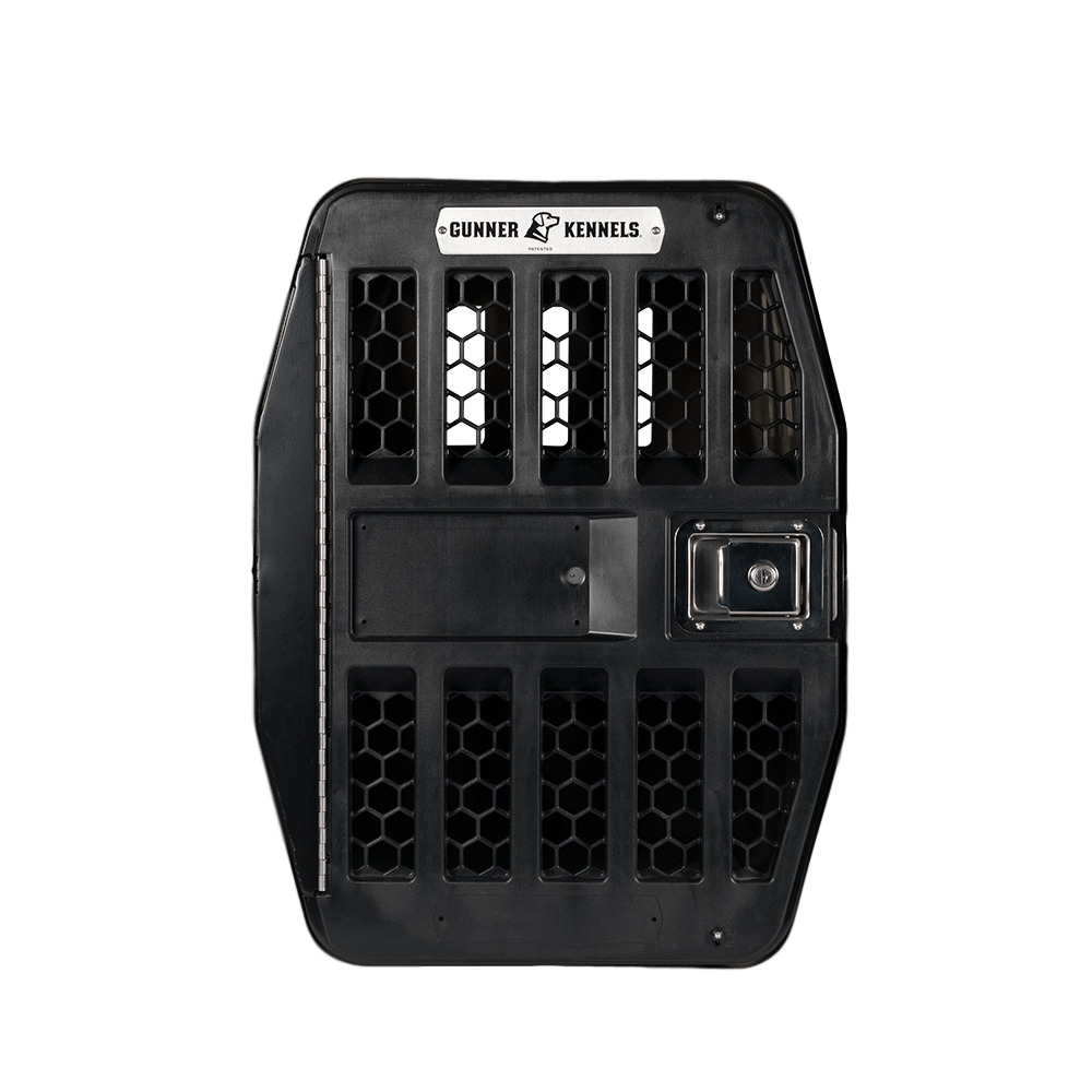 Front view of the GUNNER G1™ KENNEL DOOR in black, featuring vertical and hexagonal ventilation slots, a custom welded aluminum frame, metal lock, and the GUNNER logo at the top.