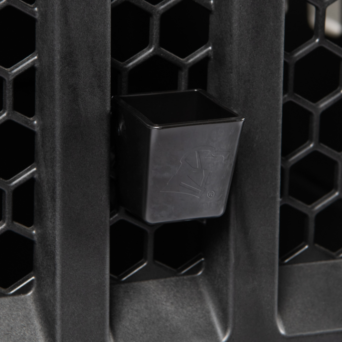 Close-up of a black plastic attachment with an embossed dog head logo on a G1 Kennel door’s honeycomb pattern, designed for dog hydration and compatible with the KENNEL BOWL.