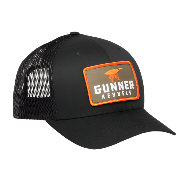 The BLACK MALLARD TRUCKER by GUNNER is a custom black trucker hat with a curved bill, mesh back, and an orange-and-brown front patch featuring an orange dog silhouette and the GUNNER name.