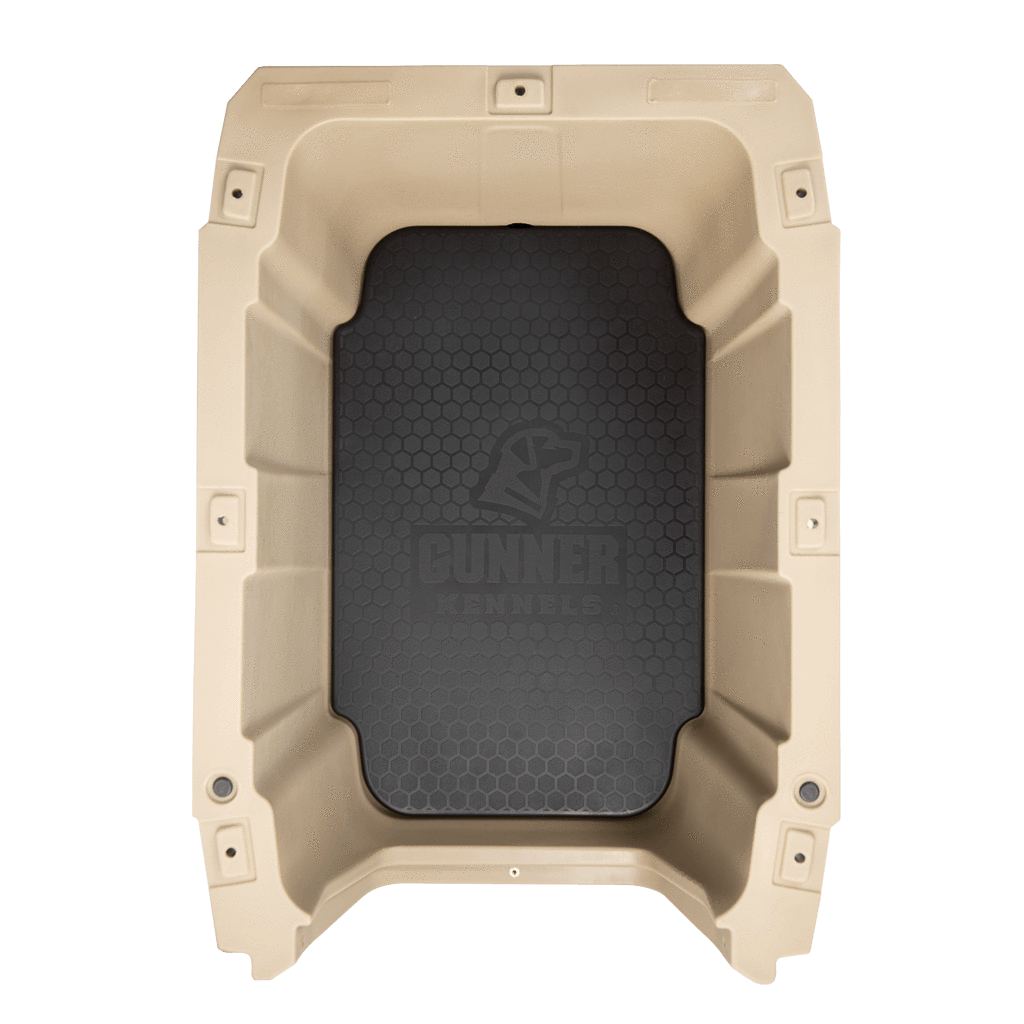 Top view of the GUNNER PERFORMANCE PAD, a beige sporting dog crate pad with tough-skin insert, black textured floor embossed with the Gunner logo, reinforced corners, and bolt holes around its edges.