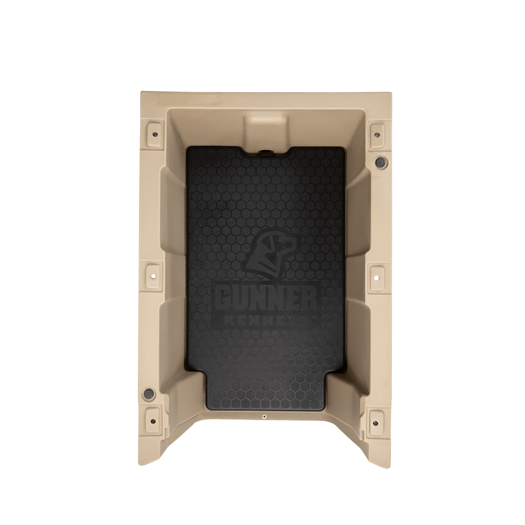 Top-down view of a tan plastic dog crate with reinforced sides. Inside is the GUNNER PERFORMANCE PAD, a tough-skin insert mat with a honeycomb pattern and the GUNNER logo in the center.